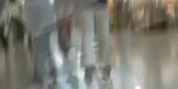 Hot brunette w/ a nice ass in a voyur porno pacing in a shopping mall