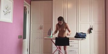 Ironing girl all naked in her house