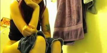 Colorful hair teen pees in bathroom