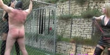 Femdom harshly punish sub with whips outdoor