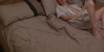 Hazel May has fun with her toy on her bed