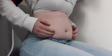 Chubby feedee playing with her belly
