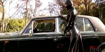 Alluring super hero in latex costume poses on cam