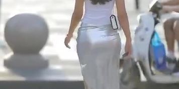 Hot body lady in shiny silver leather skirt and high heels