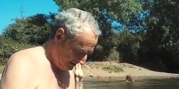 Old daddy sits with young hotties on the beach