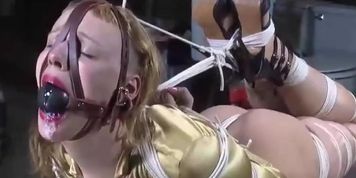 Sucking and Gurgling on a fat Ballgag while Hogtied.