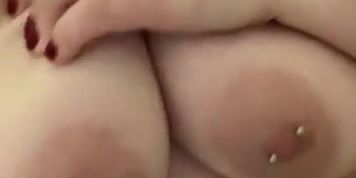 Playing with massive pierced boobs in the shower