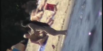 Cool babes with delicious boobs taking sunbaths on a nude beach