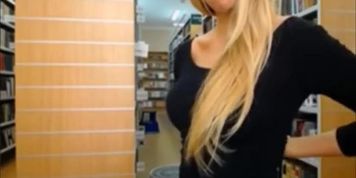 Great looking blondie disrobing and flashing tits in library
