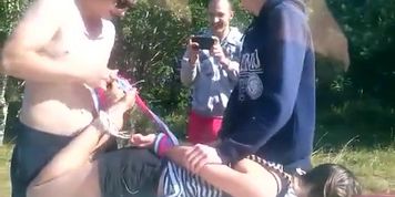 Girl tied on the hood of a car by 3 dudes