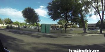 Porta Gloryhole Hot Redhead sucking cock in public porta potty