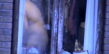 Natural look of the naked fatty amateur thru window
