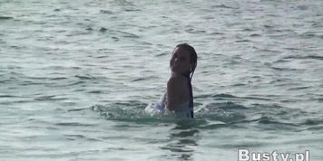 Ewa exhibits one of her breasts on the beach