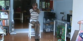 Chair Tied with an Armbinder, Leather Straps & Ballgag wearing a Turtleneck