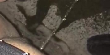 Dancer pees rough outside on concrete 