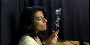 Gorgeous brunette Milf taking deep cigarette drags