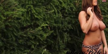 Busty brunette shows off outdoors