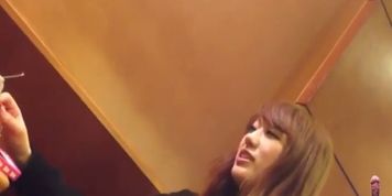 Japanese woman smoking while man gets public erection under the table