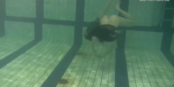 Dressed up teen Irina Barna swims sexy in the pool
