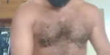 Beautiful hairy bear man shows his body at the work