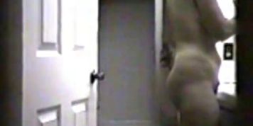 voyeur - big-titted girl with a big butt gets ready in the mirror