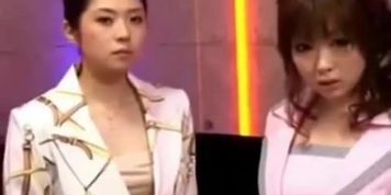 2 asian girls in costumes kissing