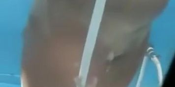 Blonde chick is pouring her tan lined boobs with shower water