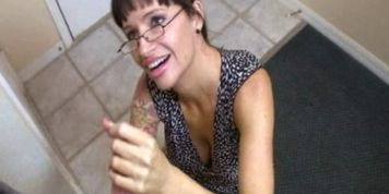 Inked MILF with glasses tugging dick